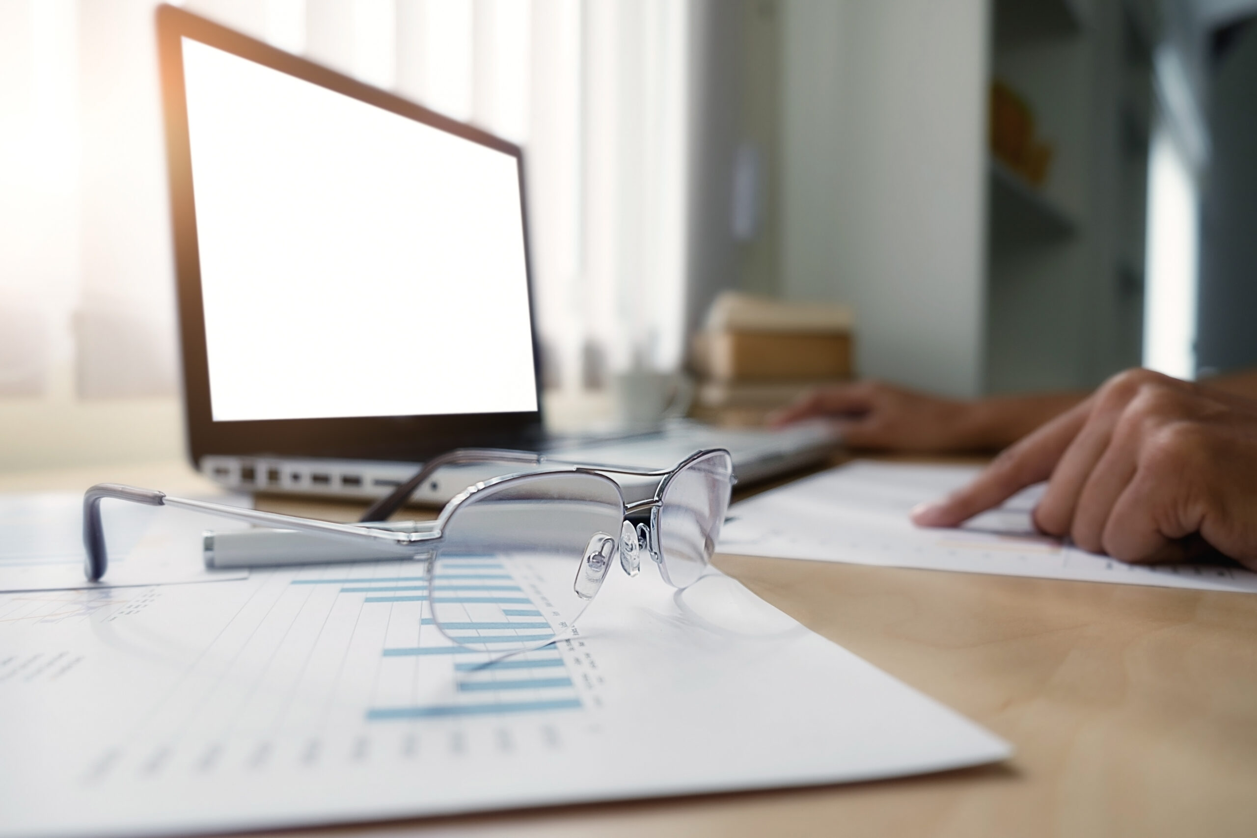 Property investor analyzing financial impact of rising insurance costs with declining profit charts